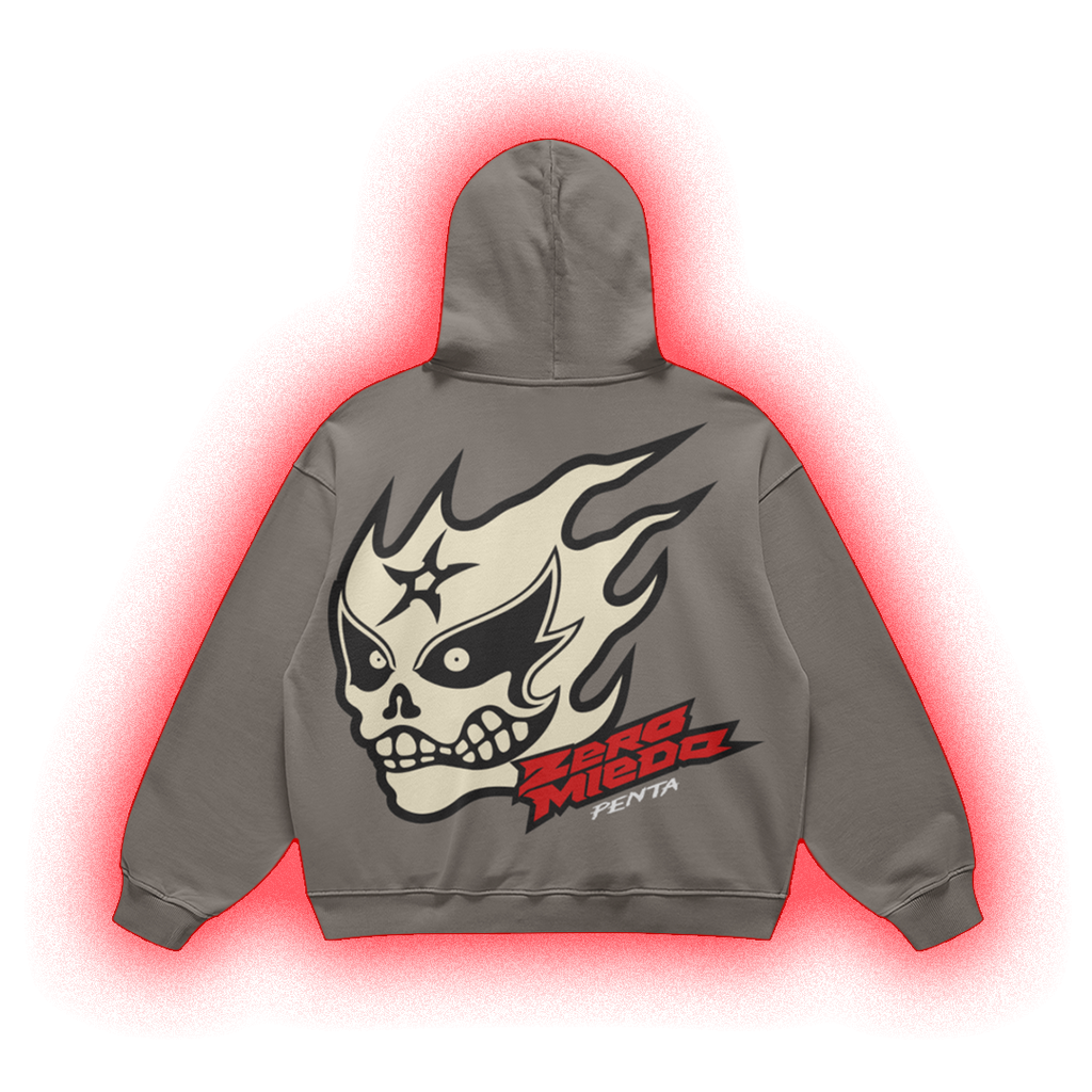 A gray pullover hoodie shown from the back, featuring a large graphic of a skull in a lucha-style mask with flames, the text 'ZORO MIEDO', and 'FENTA' in red and black. The hoodie is centered on a white background with a red glow effect around it.