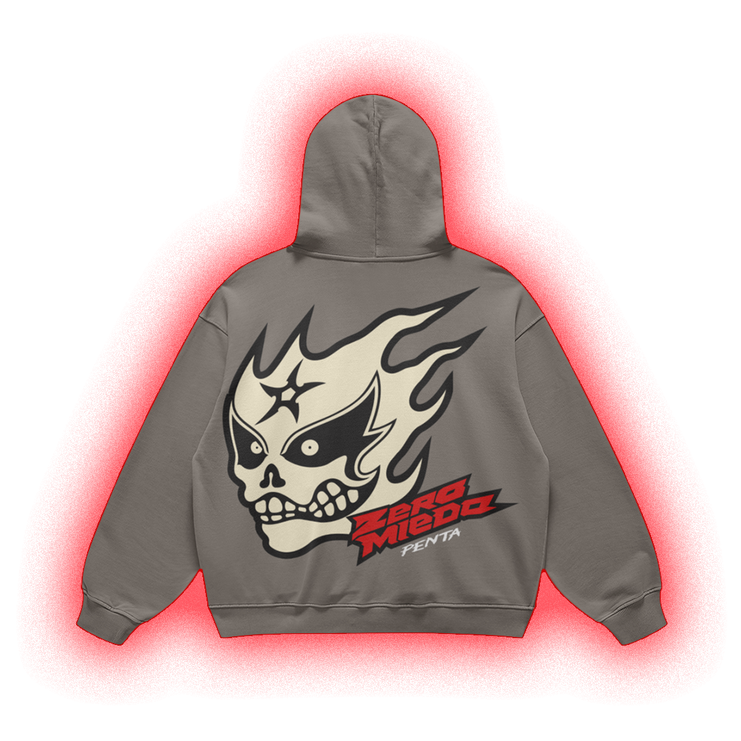 A gray pullover hoodie shown from the back, featuring a large graphic of a skull in a lucha-style mask with flames, the text 'ZORO MIEDO', and 'FENTA' in red and black. The hoodie is centered on a white background with a red glow effect around it.